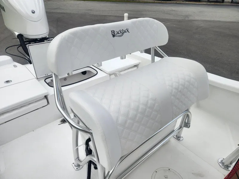 Slide: The Image of White cushioned seating on 2025 BlackJack 256 Bay boat, featuring sleek design and chrome accents. - 15