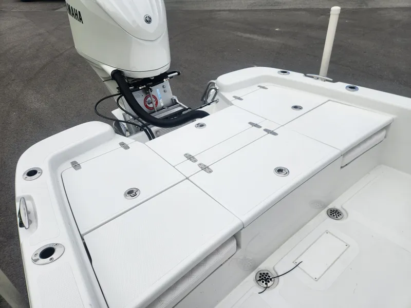 Slide: The Image of 2025 BlackJack 256 Bay boat deck with Yamaha outboard motor, featuring storage compartments. - 17