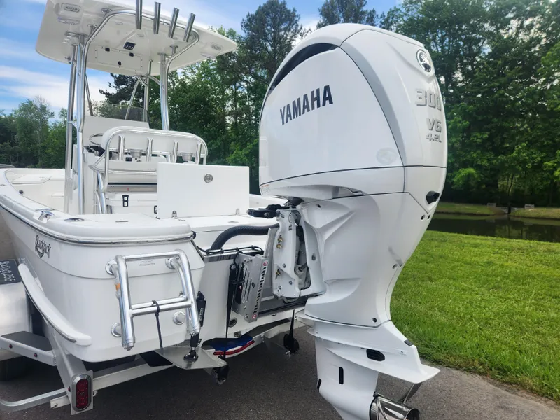 Slide: The Image of 2025 BlackJack 256 Bay boat with Yamaha 300 V6 engine, parked outdoors. - 3