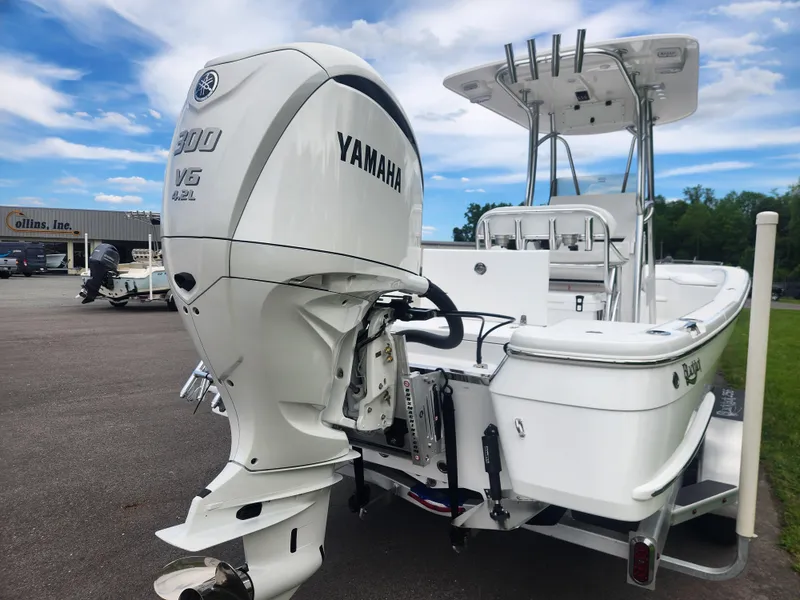 Slide: The Image of 2025 BlackJack 256 Bay boat with Yamaha 300 V6 engine, parked outdoors. - 4