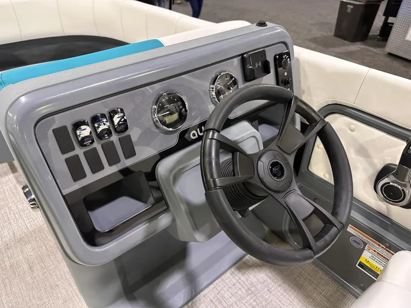 Slide: The Image of 2025 Avalon Aura 21' boat dashboard with steering wheel and control panel. - 13