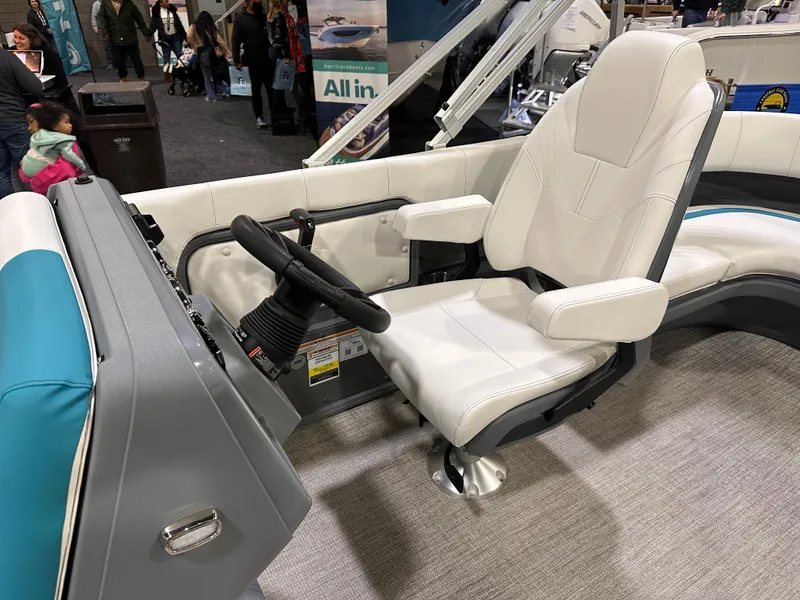 Slide: The Image of 2025 Avalon Aura 21' boat interior with white captain's chair and steering wheel. - 14