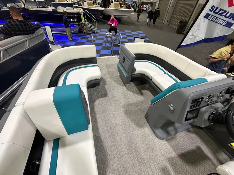 Slide: The Image of 2025 Avalon Aura 21' pontoon boat displayed indoors on blue checkered floor. - 5