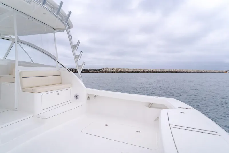 Slide: The Image of 2022 Viking 38 Open Billfish boat, spacious deck, calm waters, overcast sky. - 17