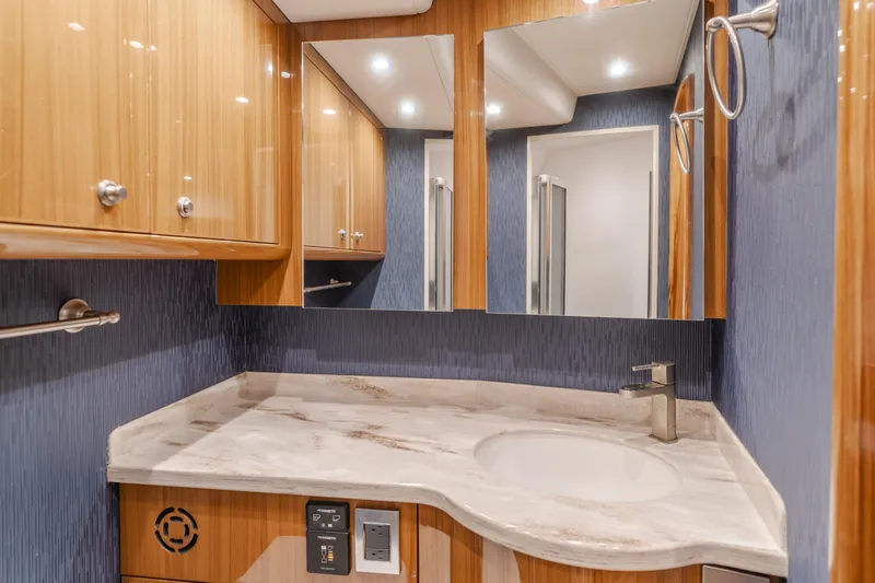 Slide: The Image of Luxurious bathroom in 2022 Viking 38 Open Billfish yacht with modern fixtures and wood cabinetry. - 2