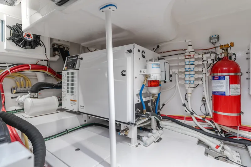 Slide: The Image of Engine room of 2022 Viking 38 Open Billfish with generator and fire extinguisher. - 22