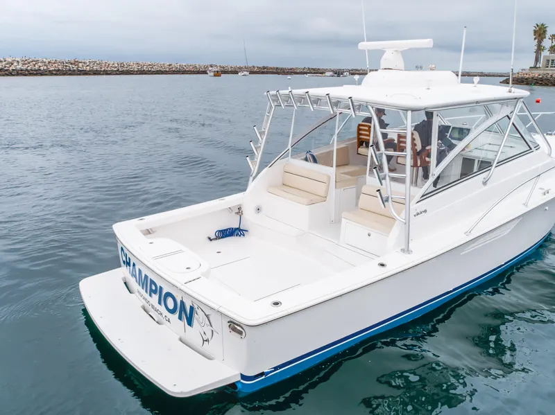 Slide: The Image of 2022 Viking 38 Open Billfish boat on calm water, rear view. - 35