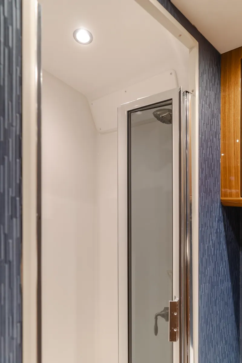 Slide: The Image of 2022 Viking 38 Open Billfish shower interior with modern design and sleek glass door. - 7