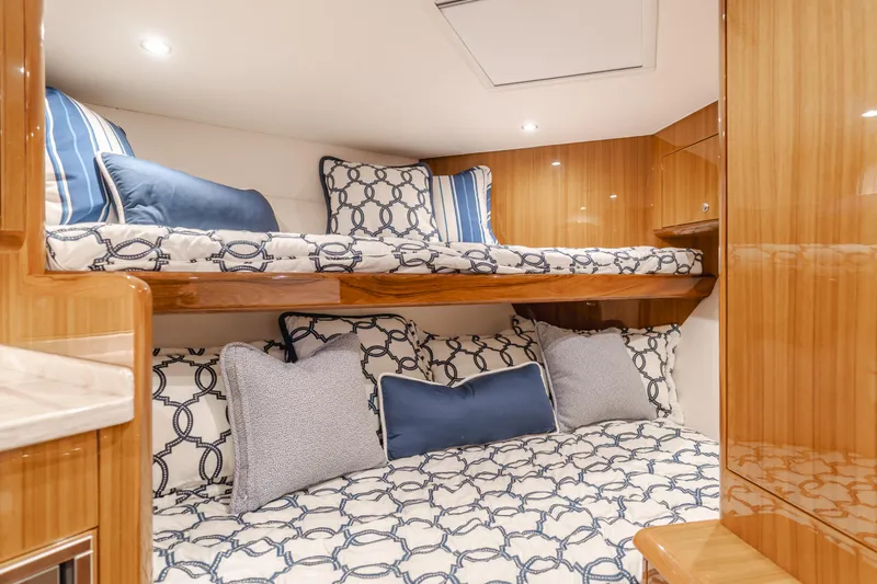 Slide: The Image of Luxurious cabin interior of 2022 Viking 38 Open Billfish with stylish bedding and wood finish. - 8