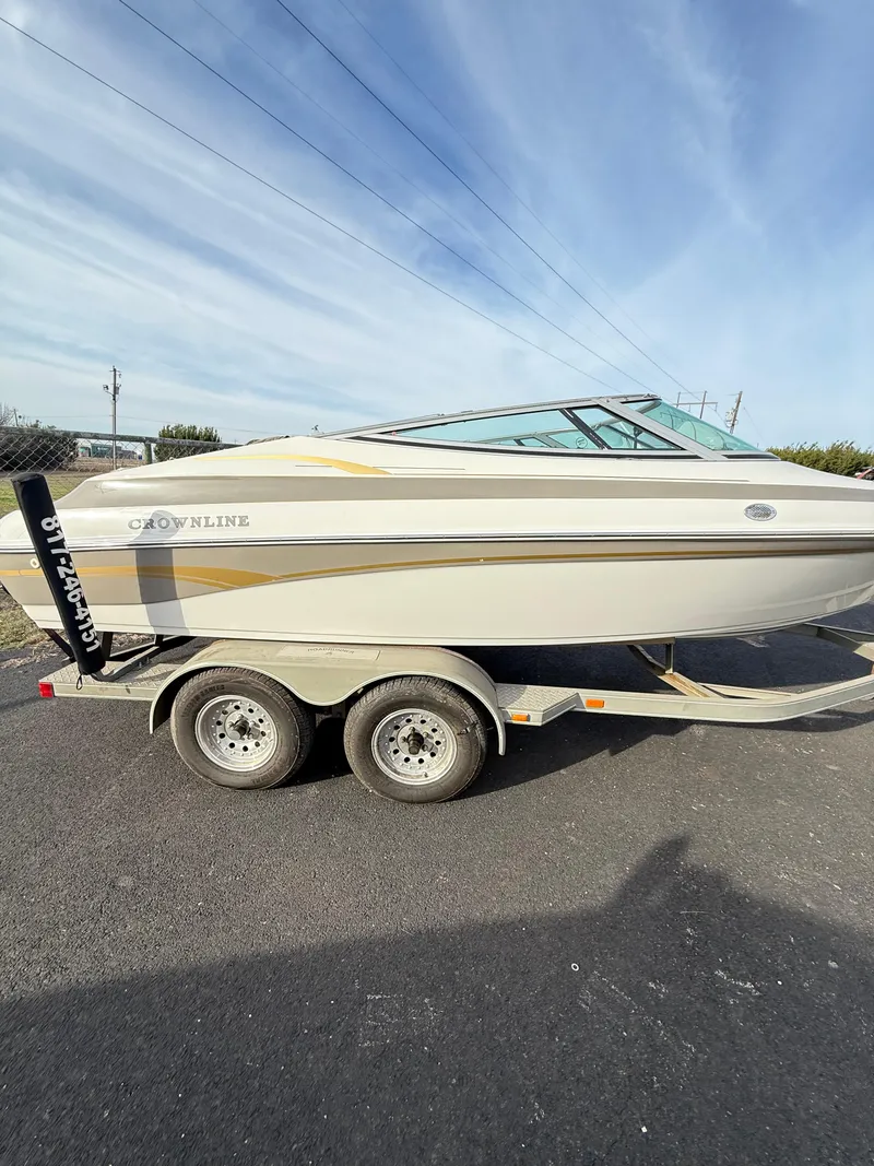Slide: The Image of 2001 Crownline 202 BR boat on trailer under clear sky. - 1