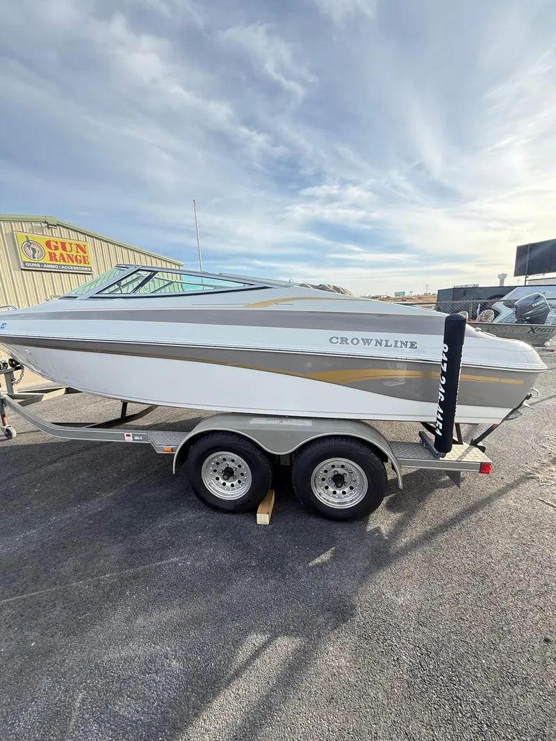 Slide: The Image of 2001 Crownline 202 BR boat on trailer, parked outdoors under a cloudy sky. - 3