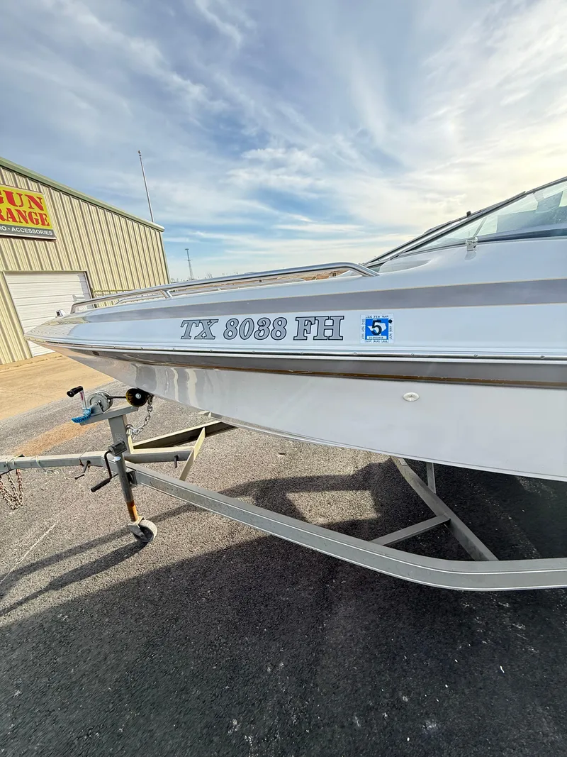 Slide: The Image of 2001 Crownline 202 BR boat on trailer, registration TX 8038 FH, parked outdoors. - 4
