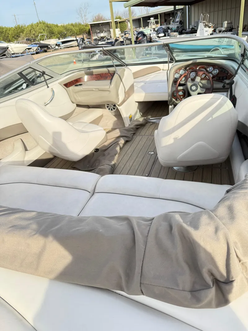 Slide: The Image of Interior of a 2001 Crownline 202 BR boat with white seating and wood accents. - 6