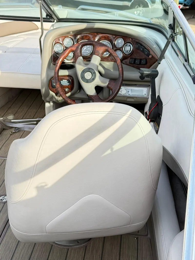 Slide: The Image of 2001 Crownline 202 BR boat interior with steering wheel and dashboard controls. - 7