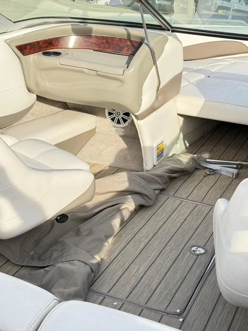 Slide: The Image of Interior of a 2001 Crownline 202 BR boat with beige seating and wood accents. - 8