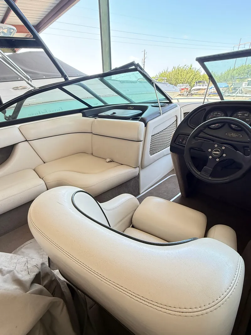 Slide: The Image of Interior of a 2002 Malibu 21 LSV boat with white leather seating. - 11
