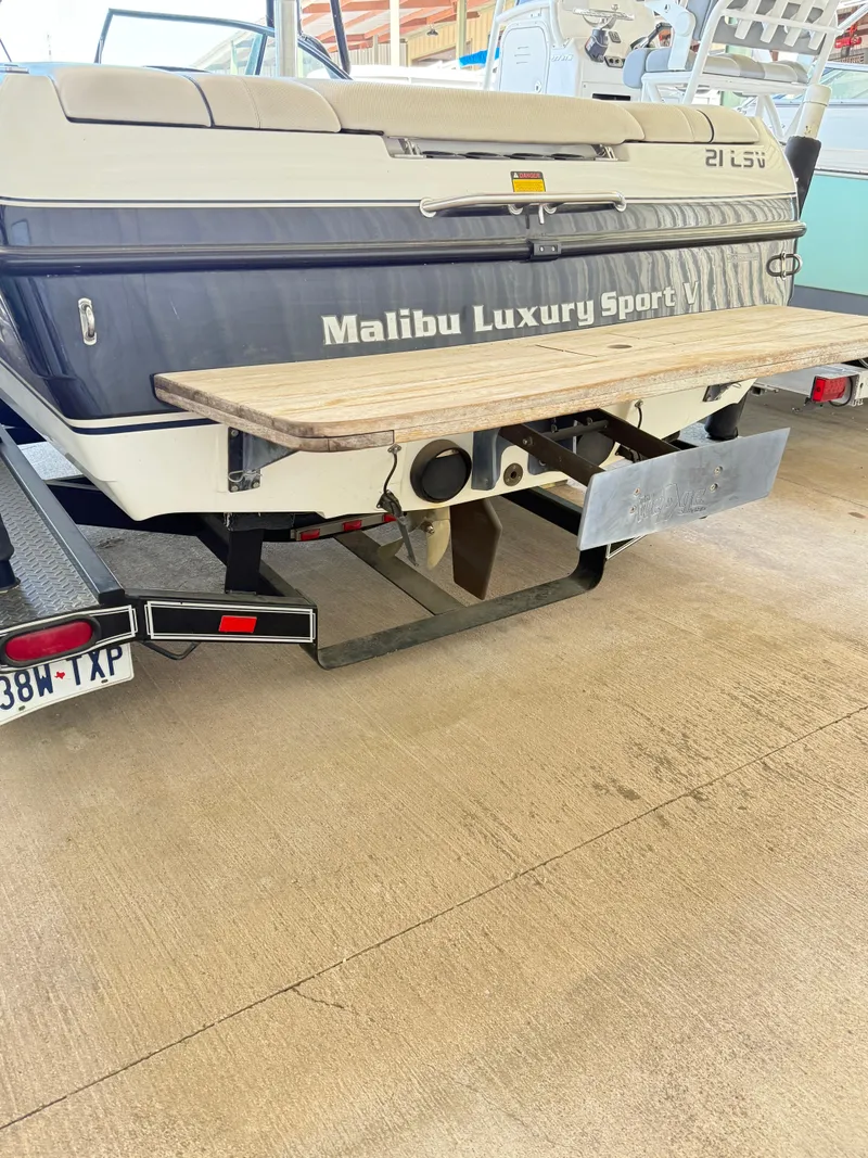 Slide: The Image of 2002 Malibu 21 LSV boat rear view with swim platform in storage. - 16
