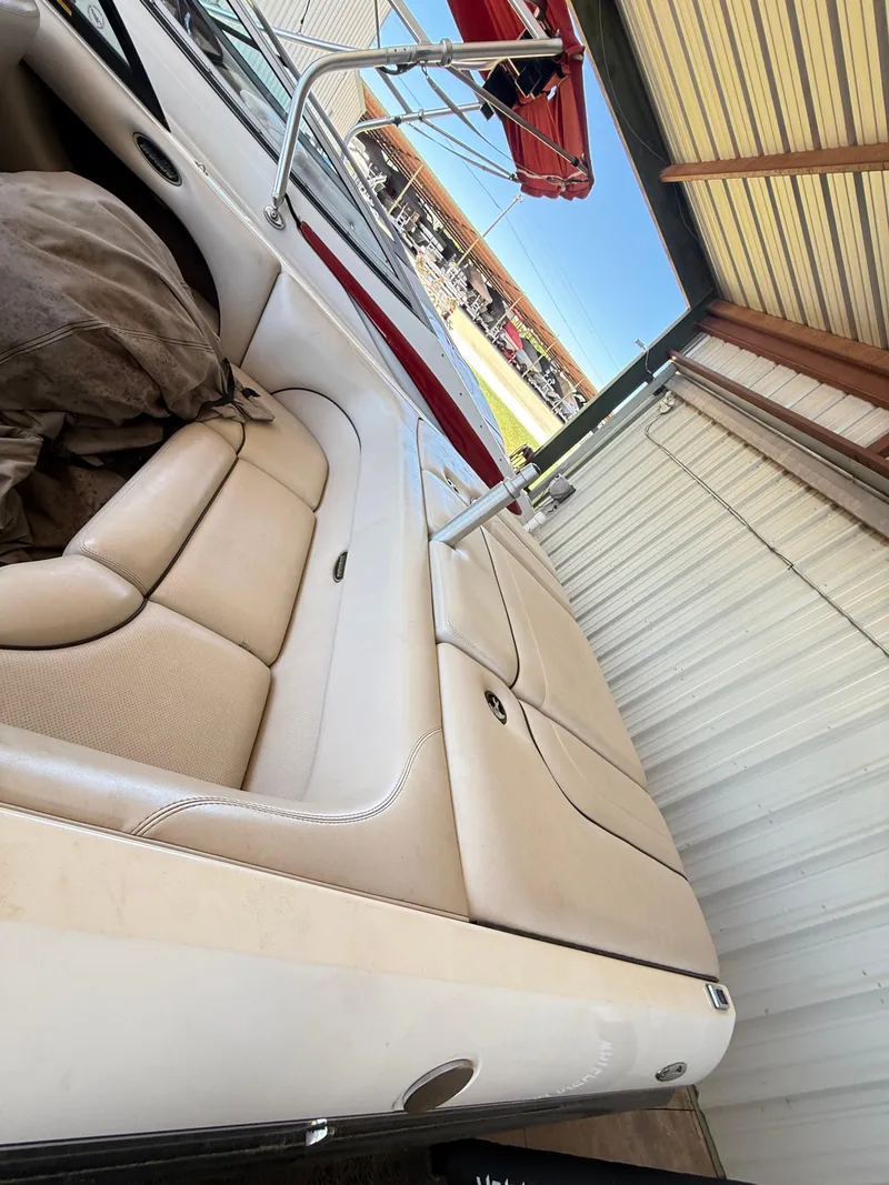 Slide: The Image of 2002 Malibu 21 LSV boat interior with beige seating in a storage facility. - 19