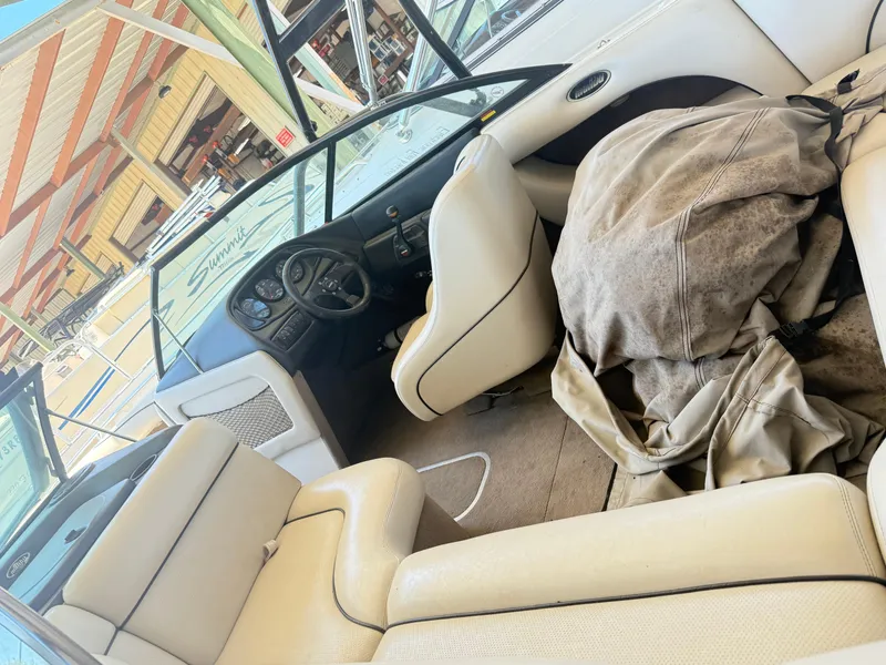 Slide: The Image of Interior of a 2002 Malibu 21 LSV boat with beige seating and dashboard. - 22