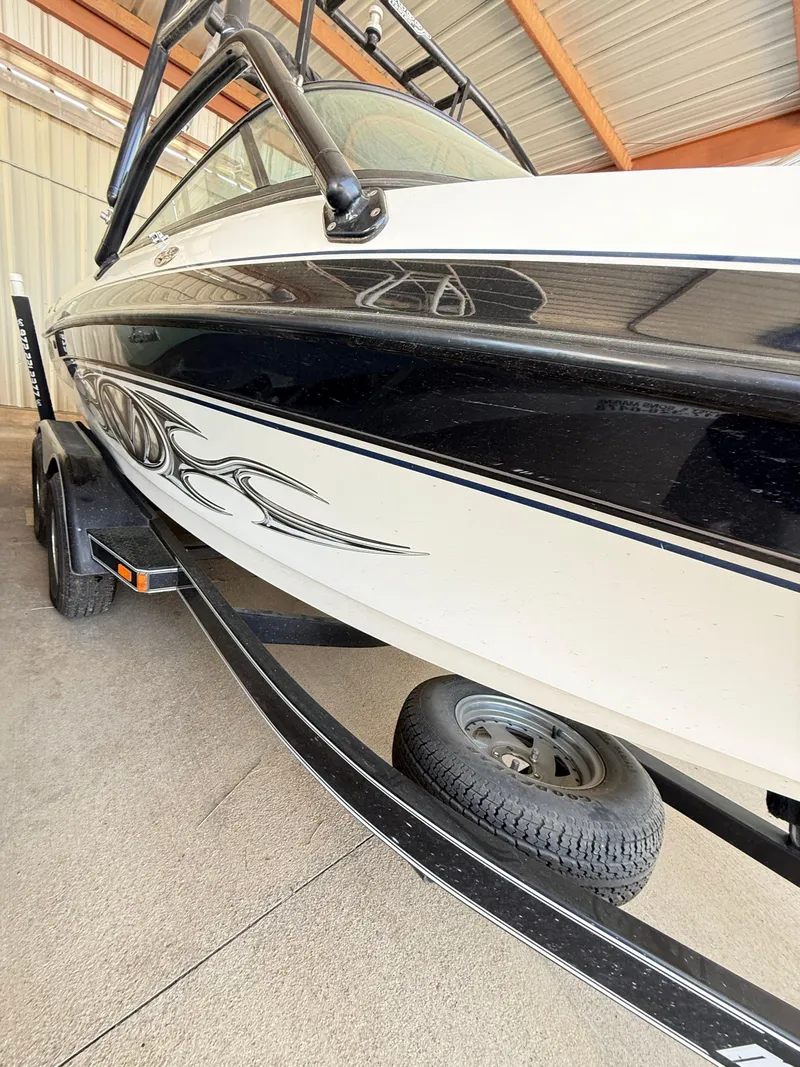Slide: The Image of 2002 Malibu 21 LSV boat on trailer in storage facility. - 6