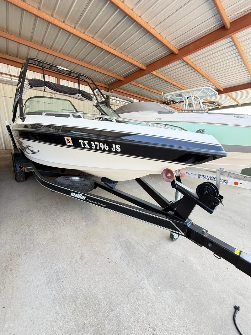 Slide: The Image of 2002 Malibu 21 LSV boat on trailer in covered storage. - 7