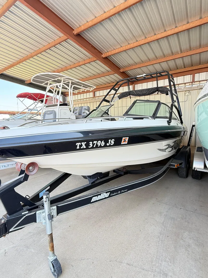 Slide: The Image of 2002 Malibu 21 LSV boat on trailer in covered storage. - 8