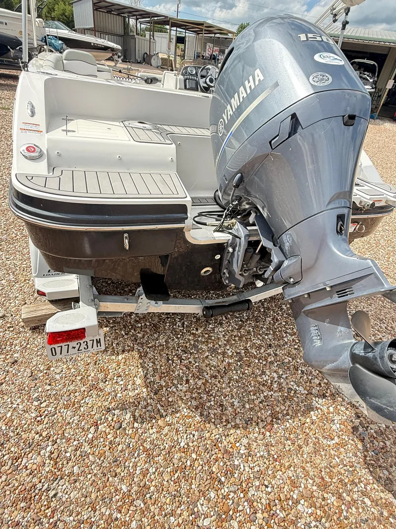 Slide: The Image of 2021 Starcraft MDX191 boat with Yamaha outboard motor on a gravel surface. - 14
