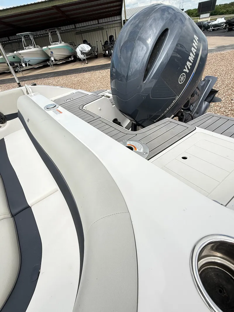 Slide: The Image of 2021 Starcraft MDX191 boat with Yamaha outboard motor, docked near other boats. - 15