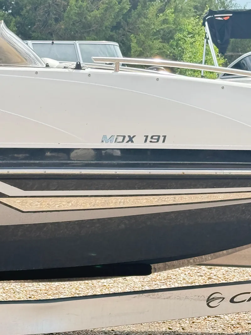 Slide: The Image of 2021 Starcraft MDX191 boat side view with logo and sleek design. - 16