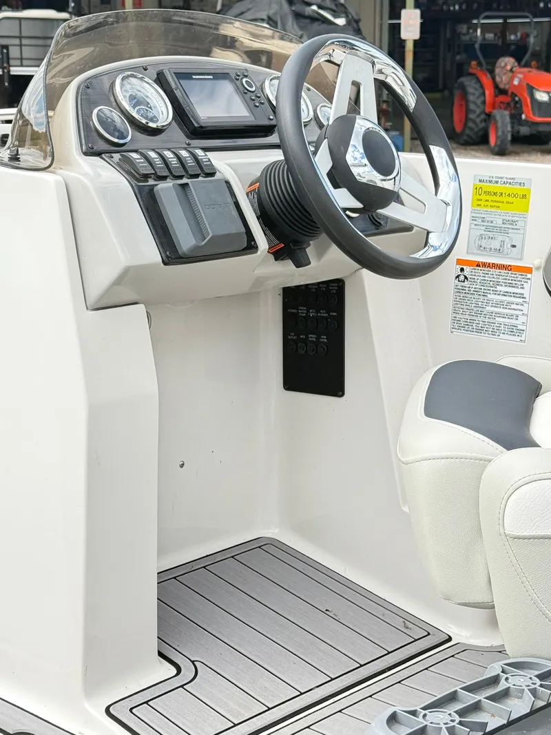 Slide: The Image of 2021 Starcraft MDX191 boat dashboard with steering wheel and control panel. - 18