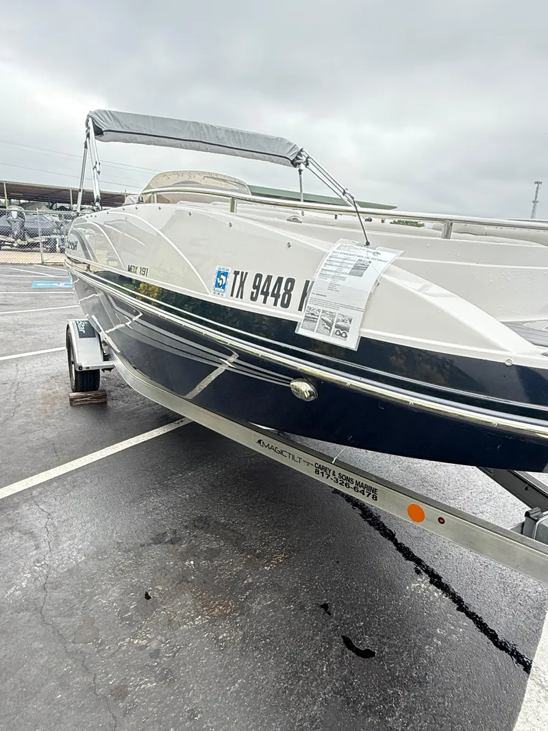 Slide: The Image of 2021 Starcraft MDX191 boat on trailer in parking lot, overcast sky. - 21