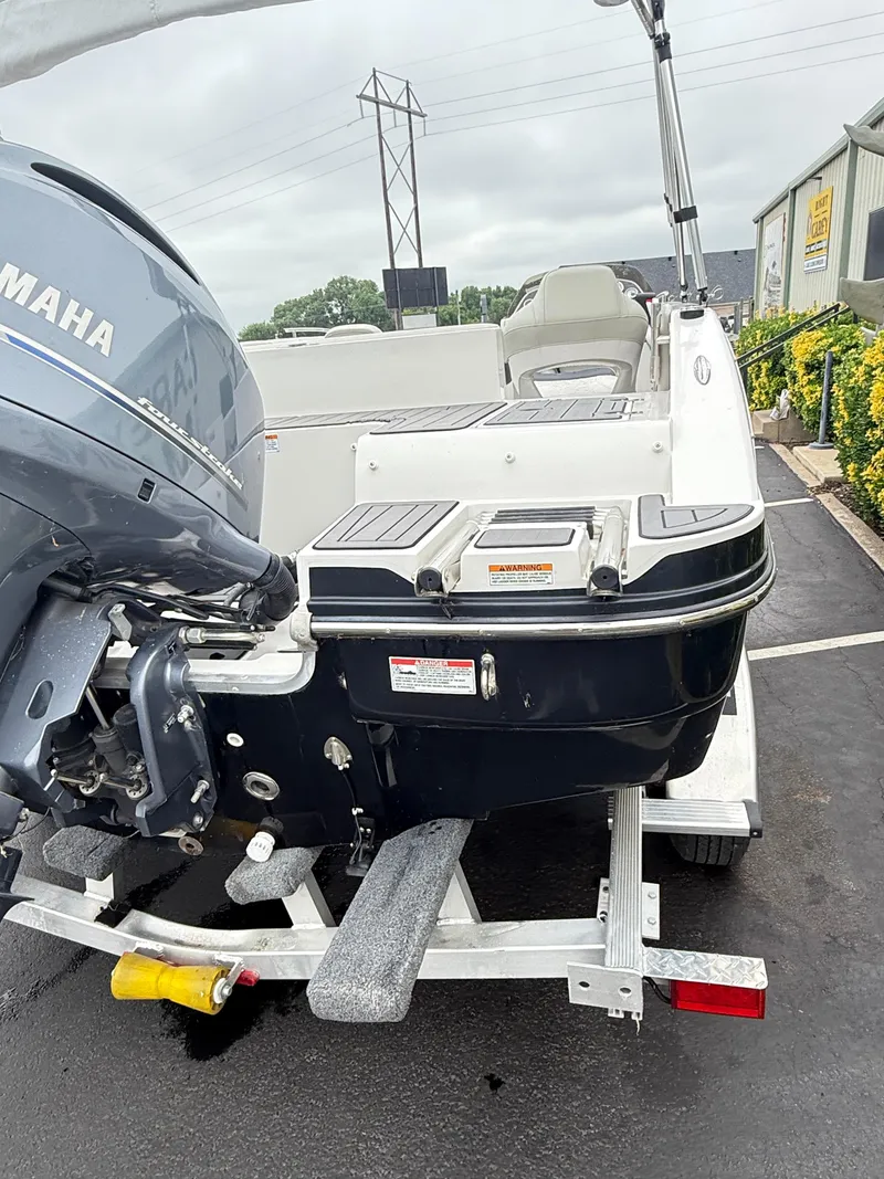Slide: The Image of 2021 Starcraft MDX191 boat with Yamaha engine on a trailer in a parking lot. - 23