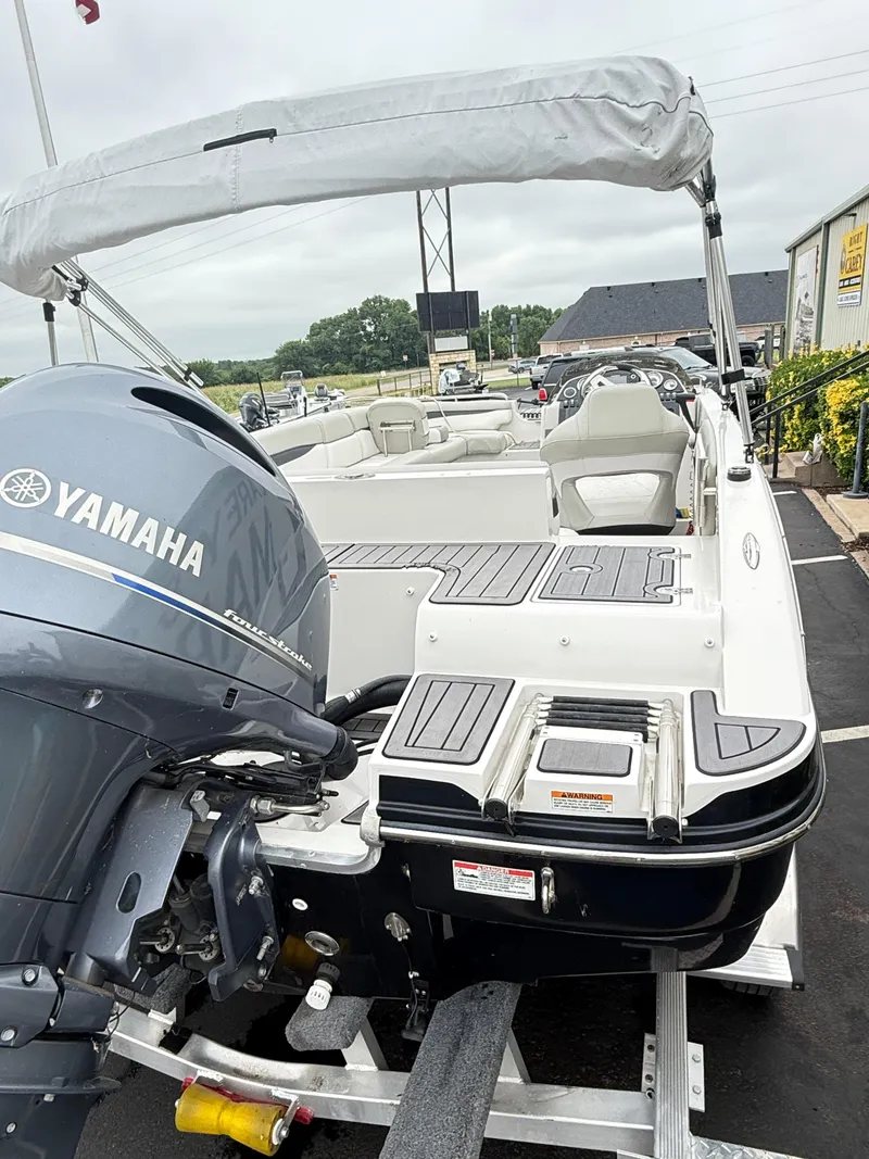 Slide: The Image of 2021 Starcraft MDX191 boat with Yamaha outboard motor, docked on a trailer. - 24