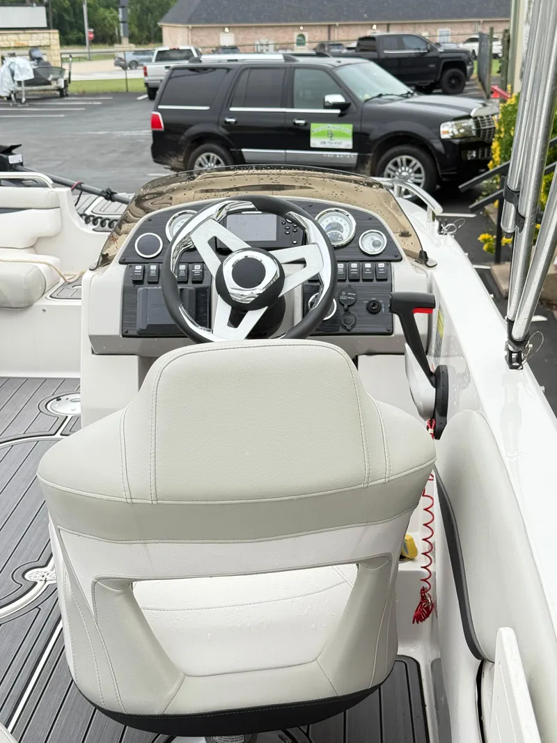 Slide: The Image of 2021 Starcraft MDX191 boat cockpit with steering wheel and dashboard controls. - 25