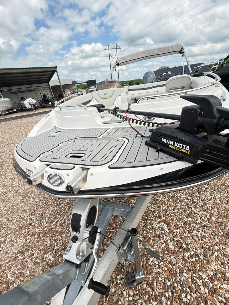 Slide: The Image of 2021 Starcraft MDX191 boat with Minn Kota motor on trailer, parked outdoors. - 9