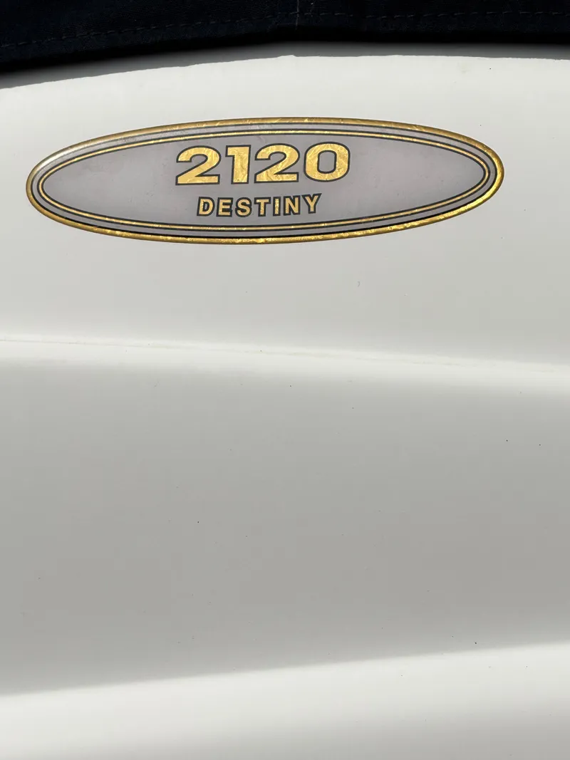 Slide: The Image of Regal 2120 Destiny 2002 model emblem on white surface. - 7