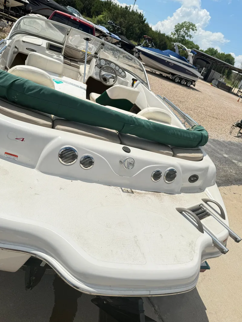 Slide: The Image of 2006 Tracker Q-4 Fish and Ski boat with green seating, parked outdoors. - 7