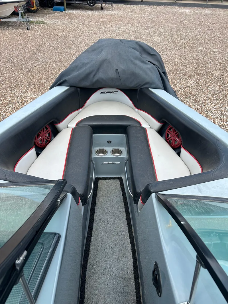 Slide: The Image of 2012 Epic 23V boat interior with cushioned seating and cup holders. - 12