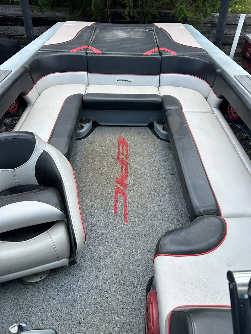 Slide: The Image of 2012 Epic 23V boat interior with gray and red seating and logo. - 13