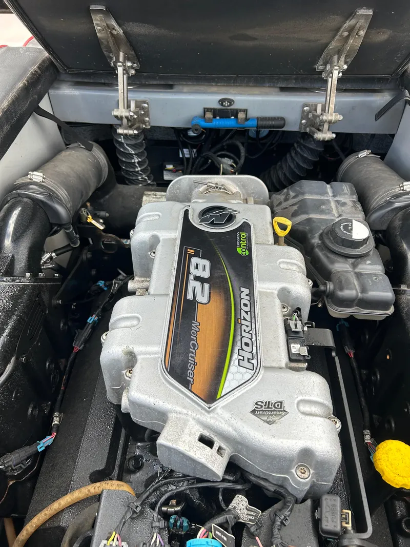 Slide: The Image of Engine compartment of a 2012 Epic 23V boat featuring a MerCruiser 8.2 Horizon engine. - 14