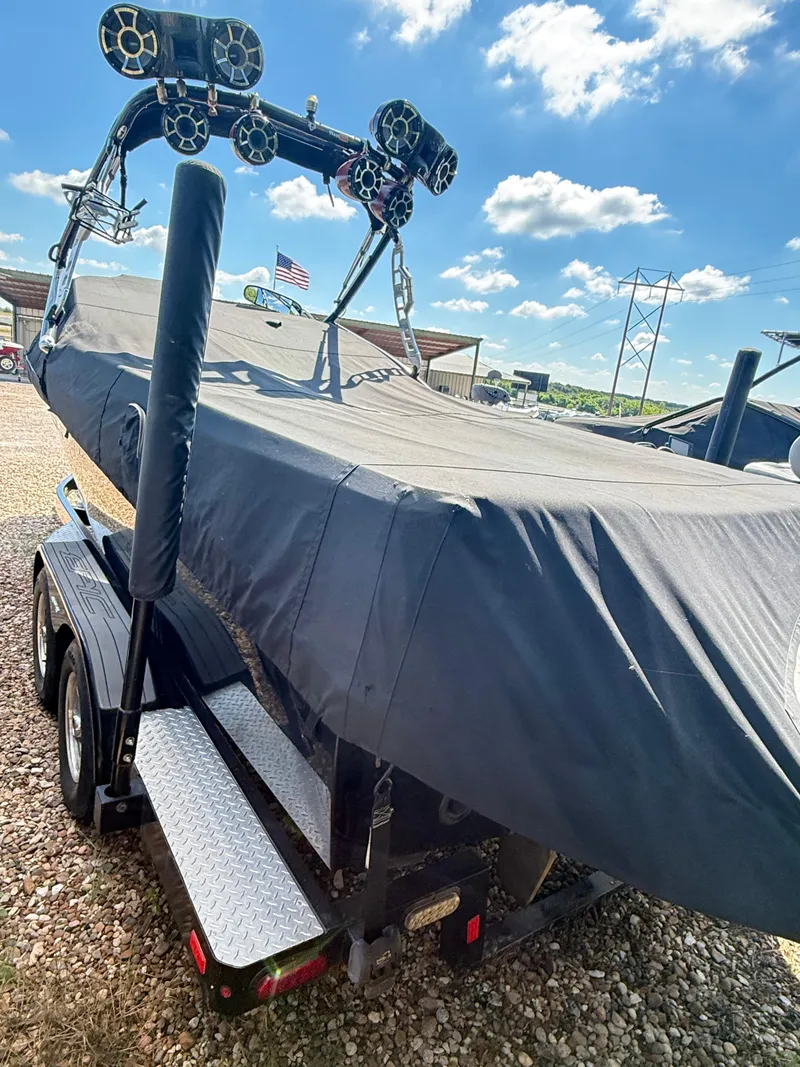 Slide: The Image of Covered 2012 Epic 23V boat on trailer under blue sky. - 5