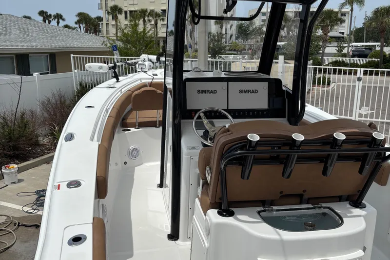 Slide: The Image of 2019 Sea Hunt Gamefish 27 boat with dual Simrad displays and brown seating. - 10