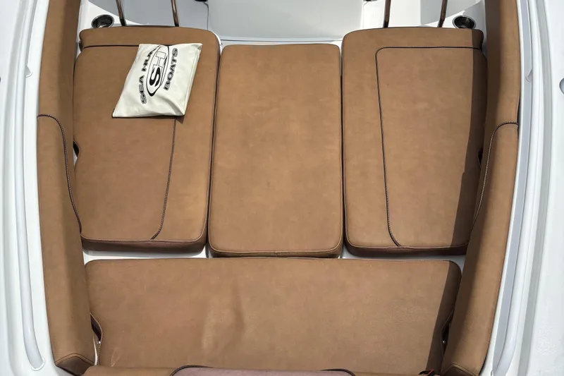 Slide: The Image of 2019 Sea Hunt Gamefish 27 boat interior with brown cushioned seating. - 11