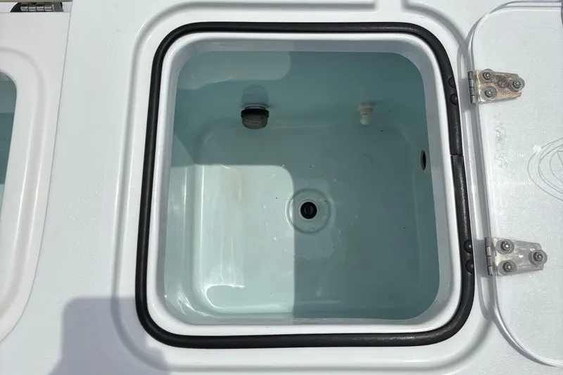 Slide: The Image of 2019 Sea Hunt Gamefish 27 livewell, open lid, white interior, square shape. - 12