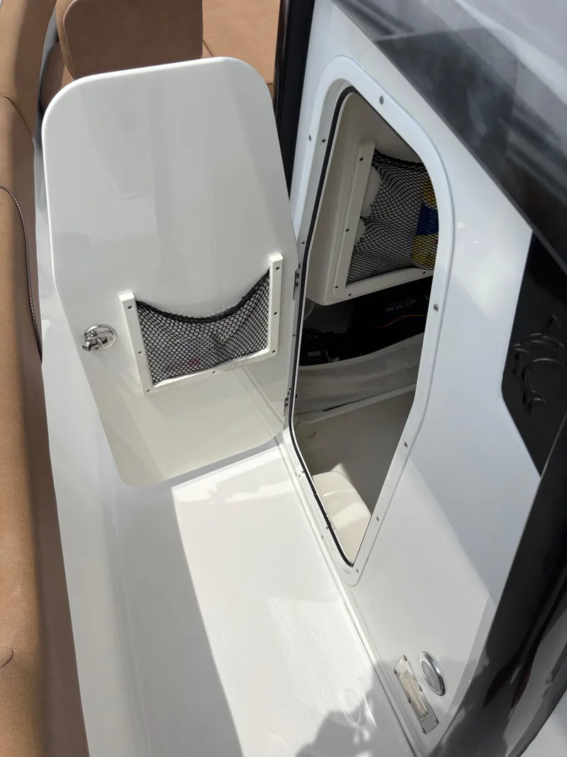Slide: The Image of 2019 Sea Hunt Gamefish 27 boat interior with storage compartment and netted pocket. - 4