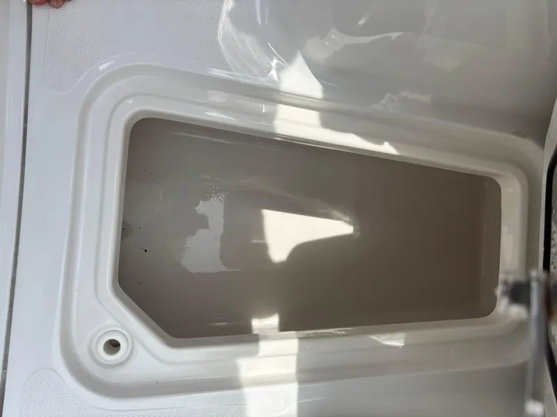 Slide: The Image of 2019 Sea Hunt Gamefish 27 storage compartment, white interior, rectangular shape. - 6