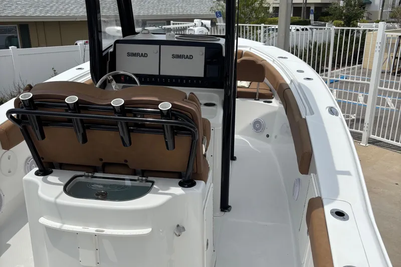 Slide: The Image of 2019 Sea Hunt Gamefish 27 boat interior with Simrad electronics and cushioned seating. - 8