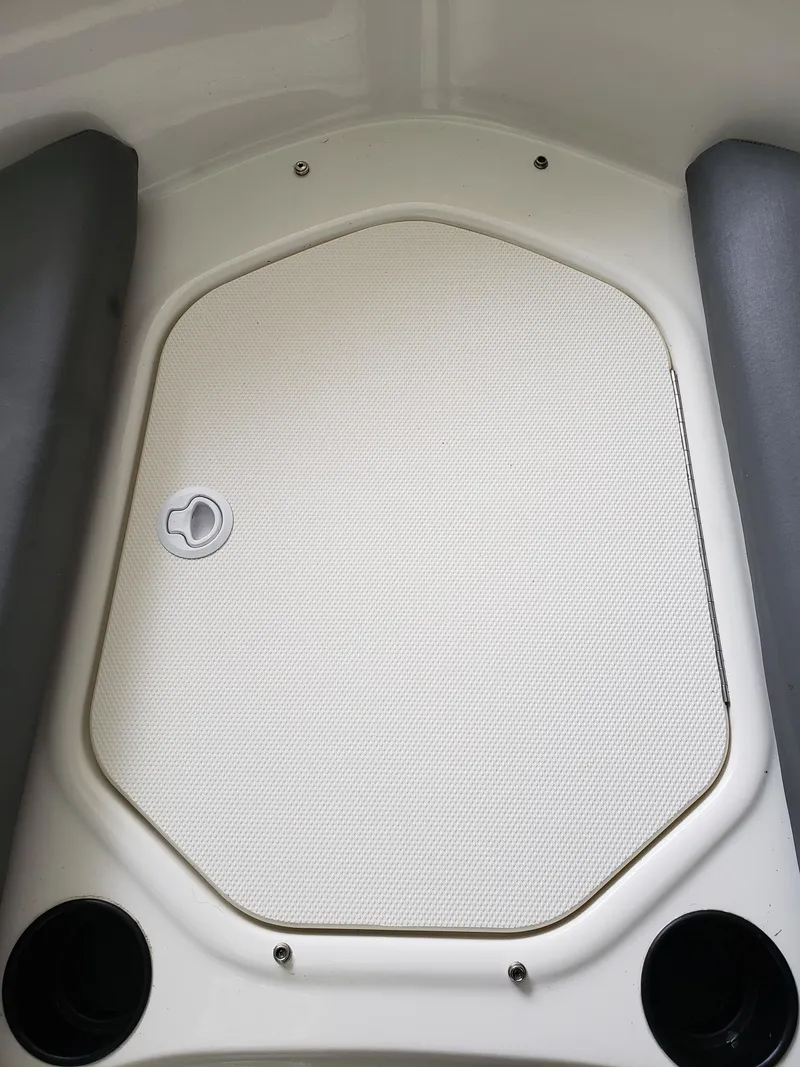 Slide: The Image of 2020 Bayliner Element E16 boat interior storage compartment with cup holders. - 4