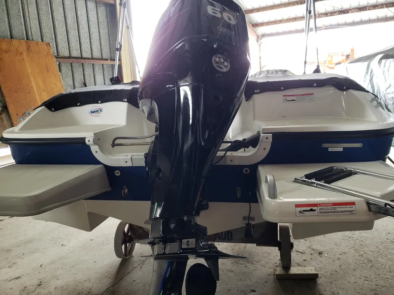 Slide: The Image of 2020 Bayliner Element E16 boat with outboard motor in a storage facility. - 6