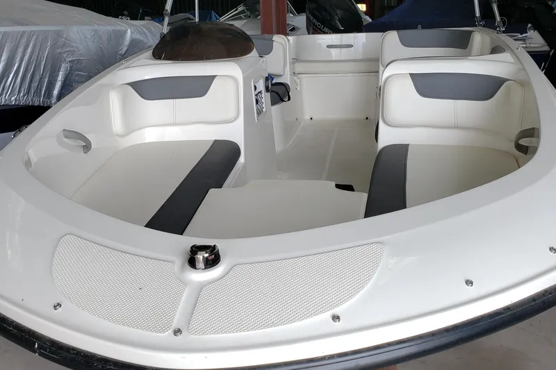 Slide: The Image of 2020 Bayliner Element E16 boat interior with white and gray seating. - 8